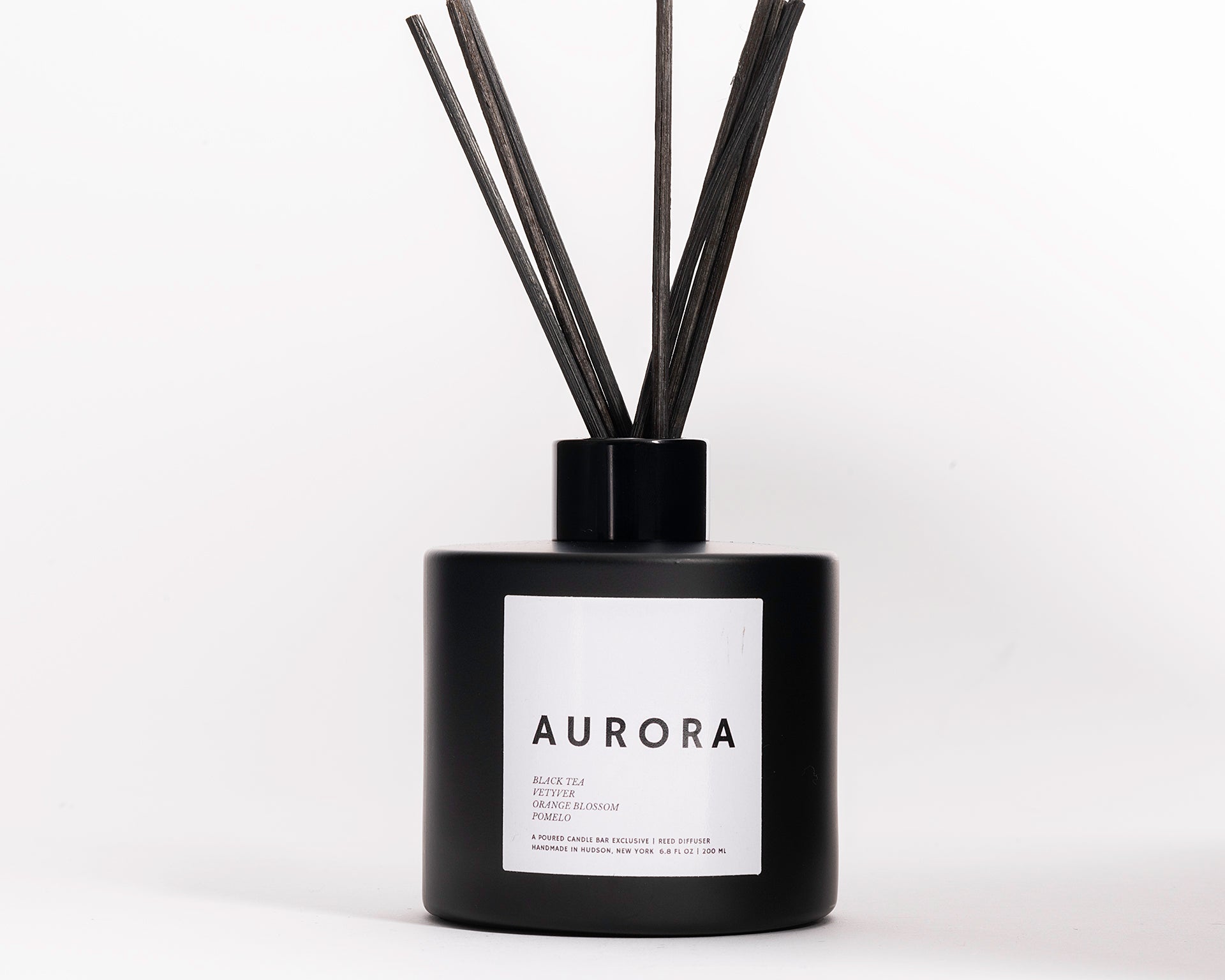 200 ml reed diffusers in a black circular glass vessel. Profile Description: Faintly sweet + herbal, with subtle hits of white floral + citrus  Notes: Black Tea, Vetyver Root, Orange Blossom, Pomelo
