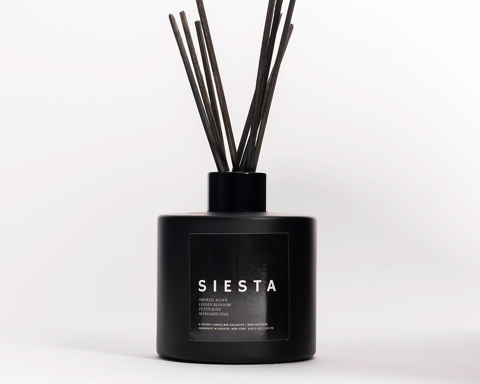 200 ml reed diffusers in a black circular glass vessel.  Profile Description:  Smoky + sweet with faint blossoms + citrus rind  Notes: Smoke, Agave, Linden Blossom, Petitgrain Oil, Mandarin Peel